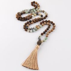 Bohemian Tribal Stone Beaded Necklace with Tassel Pendant Stylish Design Discover the beauty of nature and fashion with this statement necklace showcasing an intricate BOHO tribal stone design. This sophisticated, long strand necklace is the perfect addition to any chic look. Quality Materials Crafted with: Metal: Alloy Material: Semi-Precious Stone Perfect Length With a chain length of 104cm and a pendant length of 10.0cm, this necklace is designed to enhance your wardrobe effortlessly. Timeles Brown Bohemian Mala With 108 Beads, Bohemian Brown Mala With 108 Beads, Adjustable Bohemian Long Necklace With Tassels, Bohemian Long Necklace With Tassels, Bohemian Long Necklace For Meditation, Bohemian Mala With 108 Beads For Festivals, Bohemian Festival Mala With 108 Beads, Bohemian Beaded Necklaces With Tassels For The Beach, Bohemian Beaded Necklaces With Tassels