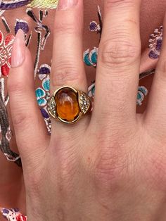 Very unusual vintage Citrine and diamond ring with center stone cabochon citrine diamond on either side , approx .36 Ct of diamond made in 18k size 5.75 , 8.53 grams . Formal Orange Diamond Ring, Vintage Diamond Cabochon Rings, Vintage Diamond Rings With Cabochon, Formal Oval Cabochon Topaz Ring, Elegant Orange Diamond Ring With Gemstone, Elegant Orange Rings With Gemstone Accents, Formal Citrine Ring With Diamond Accents, Formal Orange Rings With Gemstone Accents, Orange Rings With Gemstone Accents For Formal Occasions