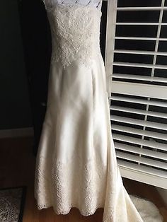 a white wedding dress hanging on a rack