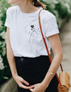 This super cute heart snap finger tee has a very soft, loose fit! So comfy and cool for a casual outfit. Tie on the side for a cropped look and style with high waist denim bottoms. ------------------------------------------------------------------------------------------------------------------------------------------------- * 100% ring-spun cotton * 4.5 oz/y² (153 g/m²) * Pre-shrunk * Shoulder-to-shoulder taping * Quarter-turned to avoid crease down the center ---------------------------------- Trendy Heart Print T-shirt For Spring, Casual Heart Print T-shirt For Summer, Trendy Relaxed Fit T-shirt With Heart Print, Casual Heart Print T-shirt With Relaxed Fit, Casual Relaxed Fit T-shirt With Heart Print, Trendy T-shirt With Heart Graphic For Everyday, Trendy Heart-shaped T-shirt For Spring, Trendy T-shirt With Heart Graphic, Trendy Heart-shaped Letter Print T-shirt