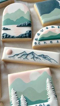 decorated cookies with mountains and trees on them