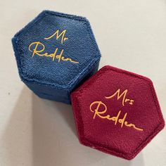 two blue and red hexagonals with gold writing on them