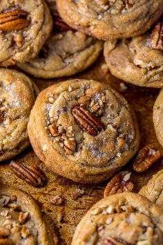 many pecan cookies are piled on top of each other with some pecans in the middle