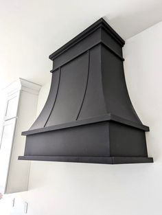 a black stove hood mounted on the wall