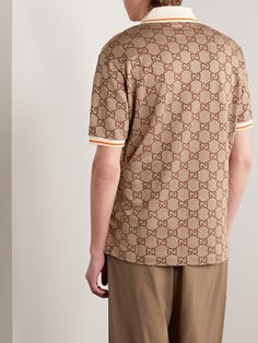 Gucci's polo shirt is jacquard-woven in its 'Maxi GG' motif, a house signature since the 1930s. It's been made in Italy from a soft silk and cotton-blend and fastens with oversized gold-tone buttons. Gucci Cotton Short Sleeve Polo Shirt, Gucci Luxury Collared Shirt, Luxury Gucci Collared Shirt, Gucci Cotton Polo Shirt, Classic Gucci Cotton Polo Shirt, Casual Gucci Cotton Polo Shirt, Gucci Classic Cotton Polo Shirt, Gucci Casual Collared Polo Shirt, Casual Gucci Polo Shirt