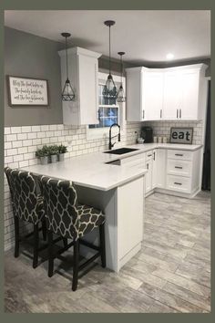 a kitchen with white cabinets and gray tile flooring