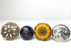 four different types of decorative knobs on white table top with black and yellow accents