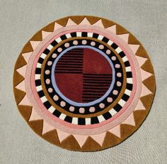 a circular rug with an abstract design on it