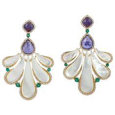 Handcrafted entirely from 18-karat gold, these stunning earrings are set with .97 carats of tanzanite, 25.54 carats mother of pearl and 1.45 carats of glimmering diamonds. FOLLOW MEGHNA JEWELS storefront to view the latest collection & exclusive pieces. Meghna Jewels is proudly rated as a Top Seller on 1stDibs with 5 star customer reviews. All items manufactured by us are handmade and can be customized or redesigned. Composition Size-58X34 MM Total Weight-25.55 Gold Weight(Gms)-18.261 Diamond Wt(Cts)-1.45 Tanzanite Wt(Cts)-0.97 Mother of Pearl Wt(Cts)-25.4 Mop Jewelry, Tanzanite Jewelry, Mother Of Pearl Jewelry, Classy Jewelry, Gold Diamond Earrings, Emerald Earrings, Pearl Earrings Dangle, Stunning Earrings, Top Seller