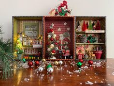 a wooden table topped with lots of christmas decorations and ornaments on top of each other