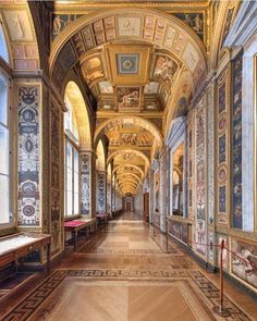 an ornate hallway with paintings on the walls