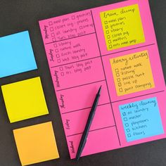 sticky notes and pen sitting on top of a table