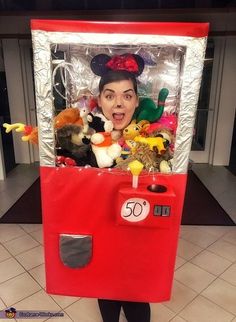 a woman is posing with stuffed animals in a vending machine for 50 cents at the store