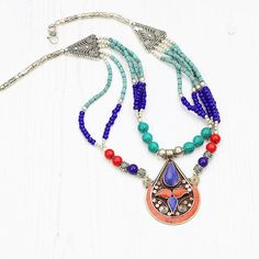 Handmade, boho style necklace for admirers of tribal and ethnic style jewellery. Specifications:Coral, Turquoise, Lapis, Ceramic beadsLength:  46 cm / 18 inchesPendant height: 6 cm / 2.4 inchesPlease note this is a handmade item crafted by Tibetan artisans, so minor imperfections are present. It makes this piece truly unique and the only one of its kind.If you have any questions feel free to message me :)EvelinaSHIPPING: First class (UK), International standard (outside UK)For more Tibetan neckl Tibetan Earrings, Boho Pendant Necklace, Boho Style Necklaces, Smoky Quartz Pendant, Bold Necklace, Jewelry Workshop, Coral Earrings, Unusual Jewelry, Boho Pendant