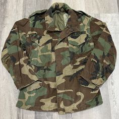 Vintage US Army Cold Weather Double Layer Woodland Camo Field Jacket Heavyweight cotton canvas with  double interior layer 4 pockets and patch  Great condition no flaws found Size XS Short Measurements  Pit to pit 20 Length 28 Retro Cotton Utility Jacket For Outdoors, Camouflage Long Sleeve Cotton Outerwear, Camouflage Cotton Long Sleeve Outerwear, Camouflage Cotton Outerwear With Flap Pockets, Military Style Khaki Outerwear With Patches, Combat Style Cotton Outerwear For Fall, Vintage Cotton Utility Jacket With Multiple Pockets, Combat Cotton Camouflage Outerwear, Camouflage Cotton Utility Jacket For Outdoor