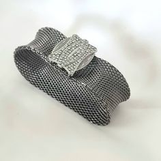 Vintage French Connection Mesh Cuff Bracelet SMALL SIZE - this has no openeing so you need to have small hands so it can slip over the hand onto the wrist.  This is absolutely stunning, it is a wide cuff bracelet in a metal mesh with a gorgeous buckle with paved details on it. The glass gems are very very small so it is hard to see of any of them are missing - it lools perfect when worn. I acquired this with the box that is shown, but unsure if it is original.  In a good vintage condition and wi Adjustable Silver Chain Bracelet With Box Clasp, Bangle Bracelet With Box Clasp As Gift, Wide Band Metal Bracelets For Formal Occasions, Silver Rectangular Metal Cuff Bracelet, Formal Wide Band Metal Bracelets, Gift Cuff Bangle Bracelet With Box Clasp, Elegant Silver Cuff Bracelet With Box Clasp, Formal Silver Cuff Bracelet With Box Clasp, Silver Wide Band Metal Bracelet