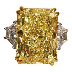 a fancy yellow diamond ring with three diamonds