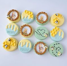 twelve buttons with winnie the pooh and honey combs on them, all decorated in different colors