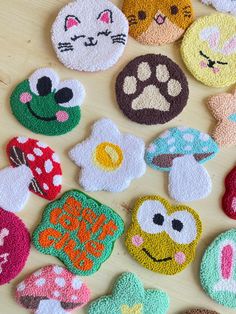 several patches with different designs on them sitting next to each other in front of a wooden table