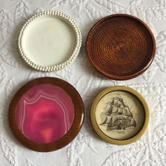 three plates and two bowls on a white tablecloth