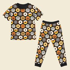 This is a presale item that ships in late August. Popoki Halloween is here! Two piece short sleeve shirt with pants pajama set. Our exclusive hand drawn print features a black background with spooky fun Halloween themed donuts of Jack-o-lantern, black cat, mummy, spiderwebs, sprinkles and stripes. Earth-friendly, hypoallergenic bamboo viscose extra gentle on sensitive and eczema-prone skin. Breathable bamboo fabric adjusts to keep children snuggly and warm in winter, and cool and comfortable in Halloween Donuts, Cat Sanctuary, Cat Pajamas, Bamboo Pajamas, One Piece Pajamas, Twirl Dress, Mens Pajamas, Bamboo Fabric, Earth Friendly