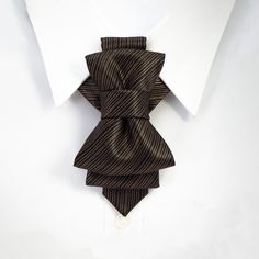 "Filled with a light metallic luster, bow tie \"Copper\" is an accessory with subtle luxury. Two pleats give Copper glamor, and we suggest it with combinations of dark brown and black suits and light shirts. This unisex accessory is a modern combination of elements found on traditional ties and bow ties. It is recommended not to tighten the regulation strip too much: Tie is at its best when leveled up with the collar line. Freestyle fashion lovers should bear in mind that this accessory also loo Wedding Brown, Wood Bowtie, Light Shirts, Unique Bow Tie, Brown Bow Tie, Necktie Crafts, Pocket Square Wedding, Prom Suits For Men, Bow Tie For Men