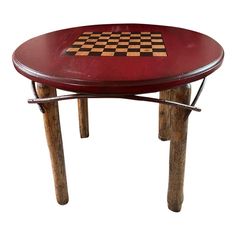 a wooden table with a chess board on it's top and some metal legs