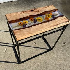 a wooden table with flowers painted on it