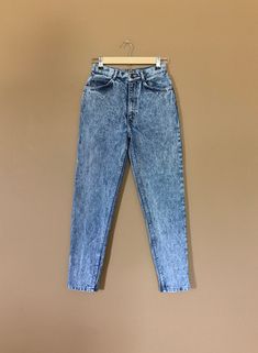 "Awesome high waisted 90's jeans. Made by Jordache. Classic acid wash denim with high waist, slim fit, tapered leg, and zipper at ankle. These jeans are in excellent clean. Perfectly worn in with great naturally distressed character. Measurements are taken zipped or buttoned up and laid comfortably flat then x2 for total circumference (inches) Jordache Jeans Made in USA 100% Cotton Waist 25\" Hips 35/36\" Total length 38.5\" Inseam 27\" Rise 11\" Top leg circumference 20\" Ankle 11\" All items a Fitted Acid Wash Vintage Bottoms, Fitted Acid Wash High Rise Bottoms, Vintage Washed Mid-rise Bottoms, Faded High Waist 90s Bottoms, 90s High Waist Faded Bottoms, Fitted Faded Bottoms In 90s Style, 90s Style Fitted Faded Bottoms, Fitted 90s Style Faded Bottoms, Faded 90s Style Fitted Bottoms