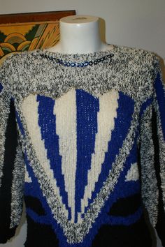 "Super cool sweater with subdued sparkly detail from the 80s by Jason Maxwell. Unique sweater in blue, white, black and grey. It gives me mad art deco vibes. Fabulous pullover sweater has blue sequin with a small seed bead in each sequin around the neck. The front features a silvery sequin also with beads. The back of the 3/4 sleeves features a different colorway from the front. Jason Maxwell 100 % Acrylic Machine Wash Separately Warm Tumble or Line Dry Made in Taiwan Tag reads size Small, but a Retro Blue Knit Sweater, Blue Retro Sweater With Graphic Print, Blue Retro Knit Sweater, Vintage Blue Knit Sweater, 80s Skirts, Cool Sweater, White Art Deco, Blue And White Art, Unique Sweater