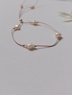 Minimalist Style Dainty Pearl Silk bracelet Tiny quality Grade AAA ivory freshwater pearls and larger pearls, very luxurious entwined on natural beige silk for a strong but delicate look Silk Cord Adjustable size small bracelet. If you require a larger size get in touch for a price. 14k rose gold filled toggle bead Handmade in my home studio If you wish to have guaranteed next day delivery - choose the delivery upgrade listing https://www.etsy.com/uk/listing/1013365129/delivery-upgrade-uk-only?r Silk Bracelet, Beige Silk, Small Bracelets, Dainty Bracelet, Etsy Bridesmaid Gifts, Silk Cord, Minimalist Bracelet, Dainty Bracelets, Home Studio