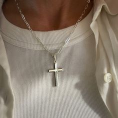 A solid sterling silver cross hangs from a flat paperclip chain giving a modern update to the time-honoured cross necklace. * The cross pendant can easily slide on and off so the chain to be worn on its own. * The clasp can be done up anywhere along the chain allowing it to be worn at different lengths. * If you're unsure of chain length I recommend going with longer as the chain is adjustable.  * Chain is 3.5 x 9mm links, the cross measures 34mm x 20mm plus a 10mm bale. * all components are sol Everyday Silver Cross Pendant Necklace, Silver Crucifix Necklace For Everyday, Sterling Silver Cross Necklace With Pendant, Silver Crucifix Jewelry For Everyday Wear, Everyday Sterling Silver Cross Necklace, Minimalist Silver Cross Pendant Jewelry, Silver Crucifix Cross Necklace For Everyday, Everyday Silver Crucifix Jewelry, Minimalist White Gold Sterling Silver Cross Necklace