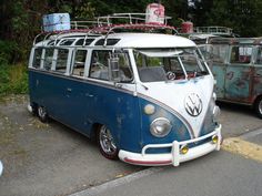 an old vw bus is parked in a parking lot