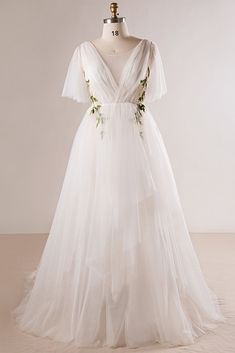 a white wedding dress with flowers on it