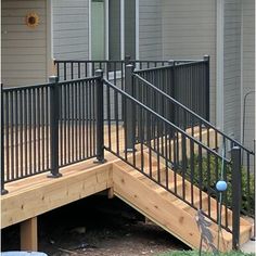 a black metal railing on the outside of a house