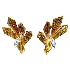 Splendid pair of 18 karat yellow gold, platinum and diamond ear clips by Grima, 1971. Crafted in 18 karat yellow gold and platinum, these beautiful earrings are designed as stylized leaves featuring a textured surface and decorated with 2 brilliant-cut diamonds and 4 single-cut diamonds totalling approximately 0.22 carats. They are completed by comfortable omega clip backs and fit well for unpierced ears. Andrew Grima (1921 – 2007) was an Anglo-Italian designer who became known as the father of modern jewellery design in Britain. He was one the most influential jewellery designer of the post-war period and enormously popular, his creations being worn by members of the Royal Family and other celebrities. The earrings have been recently professionally cleaned and are in very good condition. Andrew Grima, Brass Jewellery, Modern Jewellery Design, Modern Jewellery, Gold N, Ear Clips, Jewellery Designer, Italian Designer, Brass Jewelry