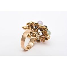 This is part of Chairish’s Fine Jewelry assortment.  This ever so chic vintage 1960's 14K Gold cluster dome cocktail ring or everyday ring has various round stones in interspersed jade, amethyst, coral and black and white onyx. The gold spiral forms are of raised height. it is a size 7 and can be sized to fit you at your end. This is a forever ring with great dimension. It could go everyday day to evening wear. PLEASE NOTE: WE ARE ONLY ABLE AND WILLING TO DO ONE MARKDOWN AND THIS IS THE FINALE PRICE NOW.  Dimensions reference the ring size and are not specific to the ring itself. Vintage Pearl Ring With Gemstone, Vintage Gold Multi-stone Cluster Ring, Vintage Dome Ring With Cabochon In 14k Gold, Vintage Multi-stone Cluster Ring, Vintage Multi-stone Pearl Ring For Anniversary, Elegant Multi-stone Dome Ring For Anniversary, Vintage Multi-stone Emerald Ring In 14k Gold, Vintage Multi-stone Rings For Formal Occasions, Vintage Yellow Gold Rings For Evening