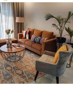 a living room with couches, chairs and a coffee table in front of a window