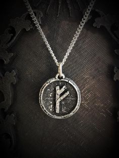 Handmade sculpture of the Germanic rune Fehu with an antique finish. Fehu is the 1st rune of the futhark and is a symbol of wealth, power, money...This Fehu rune necklace have a diameter of 2cm, and despite its cracked finish it is made very solid.This Fehu rune is handmade with a high grade and hypoallergenic alloy of 98% tin, and the chain is made of stainless steel :)If you have any more questions feel free to message me, wholesale is available for stores too :) Symbolic Bronze Jewelry, Symbolic Ceremonial Medallion Jewelry, Symbolic Bronze Jewelry For Rituals, Symbolic Medallion Jewelry For Ceremonial Occasion, Sterling Silver Medallion For Blessing Occasion, Engraved Bronze Jewelry Gift, Symbolic Coin Jewelry For Good Luck, Symbolic Engraved Brass Jewelry, Spiritual Oxidized Round Pendant Necklace