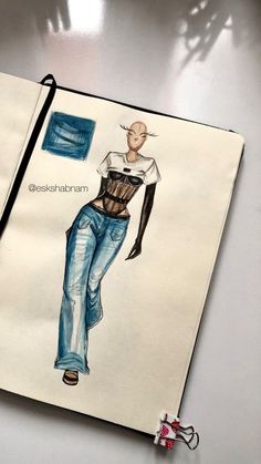 an open notebook with a drawing of a woman's torso and jeans on it