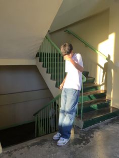 a man standing in front of a set of stairs