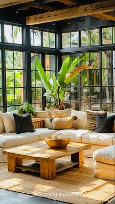 a living room filled with furniture and lots of windows