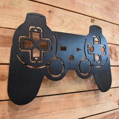 a video game controller is mounted to the wall on a wood paneled wall,