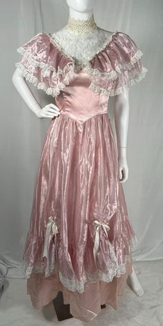 Vintage 70s/80s Gunne Sax Pink Princess Dress by Jessica McClintock - Size 5, see measurements below and in pics for best fit - Lace chest and neck - ties in back - has cute bows in front ruched skirt - has lining and netting underneath - Ruffle collar around shoulders - zips in back, buttons up neck - great vintage condition with some discoloration from age (neck, pits, and small spots on bottom of skirt) Approximate flat measurements: - Pit to Pit: 15.5" - Waist: 12" - Length: 54.5" Material: Pink Vintage Dress For Costume Party, Vintage Pink Costume Dresses, Fitted Vintage Dress With Short Sleeves For Costume Party, Fitted Victorian Dress For Spring Party, 1970s Style Fitted Vintage Dress For Vintage Events, Fitted Vintage Summer Costume Dress, Vintage Short Sleeve Dress For Costume Party, Fitted Short Sleeve Vintage Costume Dress, Fitted Short Sleeve Vintage Dress For Costumes