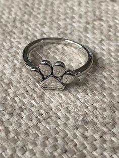 This super cute, silver color (copper plated), paw print ring is very cute.  It is not adjustable. it is a great small accessory to add to any outfit and show your love for your cat or dog Kitten Ring, Ring Cat, Paw Print Ring, Paw Ring, Cat Ring, Cat Jewelry, Kitty Cats, Copper Plated, Small Accessories