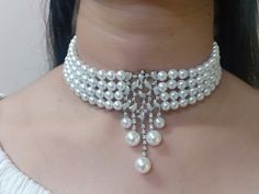 Elevate your style with our Pearl Elegance Choker Set, meticulously crafted in silver and adorned with unique 5A lab-created diamonds by CZ. These luxurious stones create a vivid and high-quality appearance, giving the jewelry a real diamond feel. Finished with 18kt gold accents and a highly-reflective rhodium polish, this set is not only stunning but also durable, ensuring it stays radiant for years to come. Finish: White Gold Plating Material: Silver, Alloy, CZ Stones, Pearls Color: White Size: One Size Closure Type: Hook and Links Box Contains: 1 Necklace and 1 Pair Earrings Classic Diamond White Jewelry For Party, Diamond White Rhinestone Jewelry For Formal Occasions, Glamorous White Round Jewelry, Luxury Pearl White Jewelry For Party, Luxury White Jewelry With Rhinestones, Diamond White Classic Jewelry With Crystals, Elegant White Jewelry With Sparkling Stones, Luxury Pearl White Party Jewelry, Classic Diamond White Jewelry With Bling