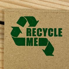 a recycle me sticker on a piece of cardboard