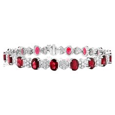 A fashionable and color-rich tennis bracelet showcasing oval cut 20 Ruby weighing 10.34 carats total, spaced by 140 flower shape round brilliant diamonds weighing 1.18 carats total. Made in 14k white gold. All diamonds are GH color SI1 Clarity. Can be made in ruby and Emerald as well. Style available in different price ranges. Prices are based on your selection. Don't hesitate to get in touch with us for more information. Oval Diamond Tennis Bracelet With Gemstones, Red Diamond Oval Tennis Bracelet, Red Diamond Oval Bracelet, Red Oval Diamond Bracelet, Black Diamond Bracelet, Diamond Pendants Designs, Bracelet Tennis, Ruby Bracelet, Diamond Pendants