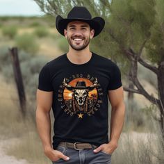 Get ready for some wild Midwestern fun with this Country Longhorn Spirit Shirt! Made for those who dare to be different, this unique shirt features a vibrant and eye-catching design that showcases the charm of the real Country Western Vibes. Whether you're a rodeo enthusiast, a cowboy at heart, or just love finding a shirt that truly stands out, this one-of-a-kind piece is perfect for adding a touch of country western to your wardrobe. Crafted with comfort in mind, this shirt is made from high-q Rodeo Short Sleeve Shirt, Pre-shrunk, Black Cotton Western T-shirt, Black Western Style Cotton T-shirt, Black Western Crew Neck Top, Black Short Sleeve Adventure Shirt, Black Short Sleeve Shirt For Adventure, Black Short Sleeve Western Tops, Black Short Sleeve Western Style Top, Midwest Style