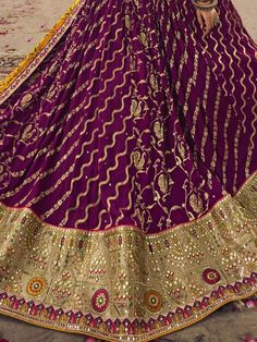 Presenting a stylish drape that suits your standard this ravishing purple color lehenga is made of viscose silk material embellished with sequin work, thread, and embroidery work. This precious purple lehenga comes with a similar color blouse of viscose silk material designed with sequin, thread, and embroidery work. It also comes with a yellow color gaji silk dupatta crafted with bandhani print work and sweet lace border. This purple wedding wear lehenga is stitched up to 42 inches. The choli w Purple Color Lehenga, Gaji Silk Dupatta, Stylish Drapes, Purple Lehenga, Bandhani Print, Color Blouse, Silk Dupatta, Lace Border, Silk Material